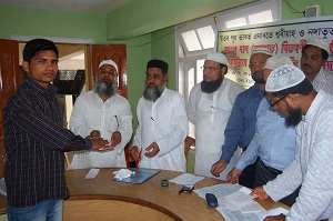 A student receives his scholarship from the officials of Emarat-e- Sharia & Nadwatut Tameer at a function held at Islampur Madrassa in Guwahati on Sunday