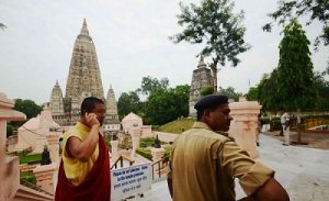 A monk and police at the premises of Mahabodhi temple in Bodh Gaya, Bihar