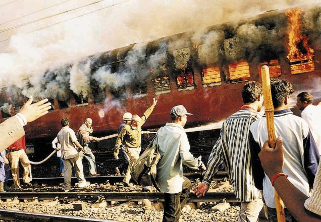 This February 27, 2002 photo shows the burning S-6 coach of the Sabarmati Express in Godhra.Photo credit  The Hindu