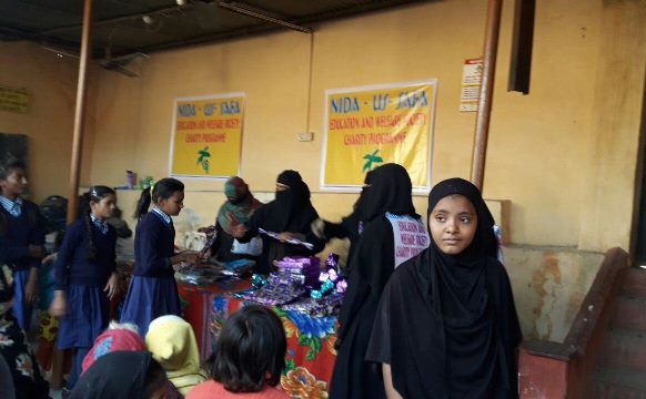 Dr. Sufiya Fatimah Husaini and her colleagues of Nida-us-Safa Education & Welfaare Society dristributing clothes to children after the education awareness workshop in in Kanchan School in Sanjay Nagar slums of Bhopal